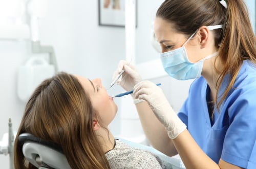 Dentist in a Pickering dental clinic assisting a patient covered by the Canadian Dental Care Plan.