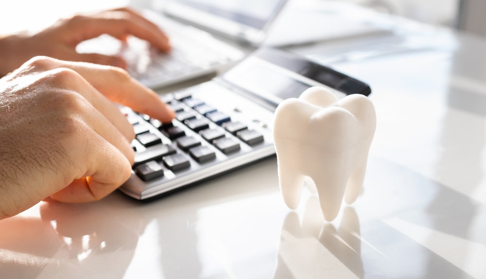 Dental clinic front desk with money and insurance papers representing financing for dental implants